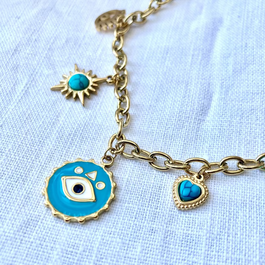 A gold-plated stainless steel necklace with a chain link, featuring a charm with an evil eye design and turquoise accents.