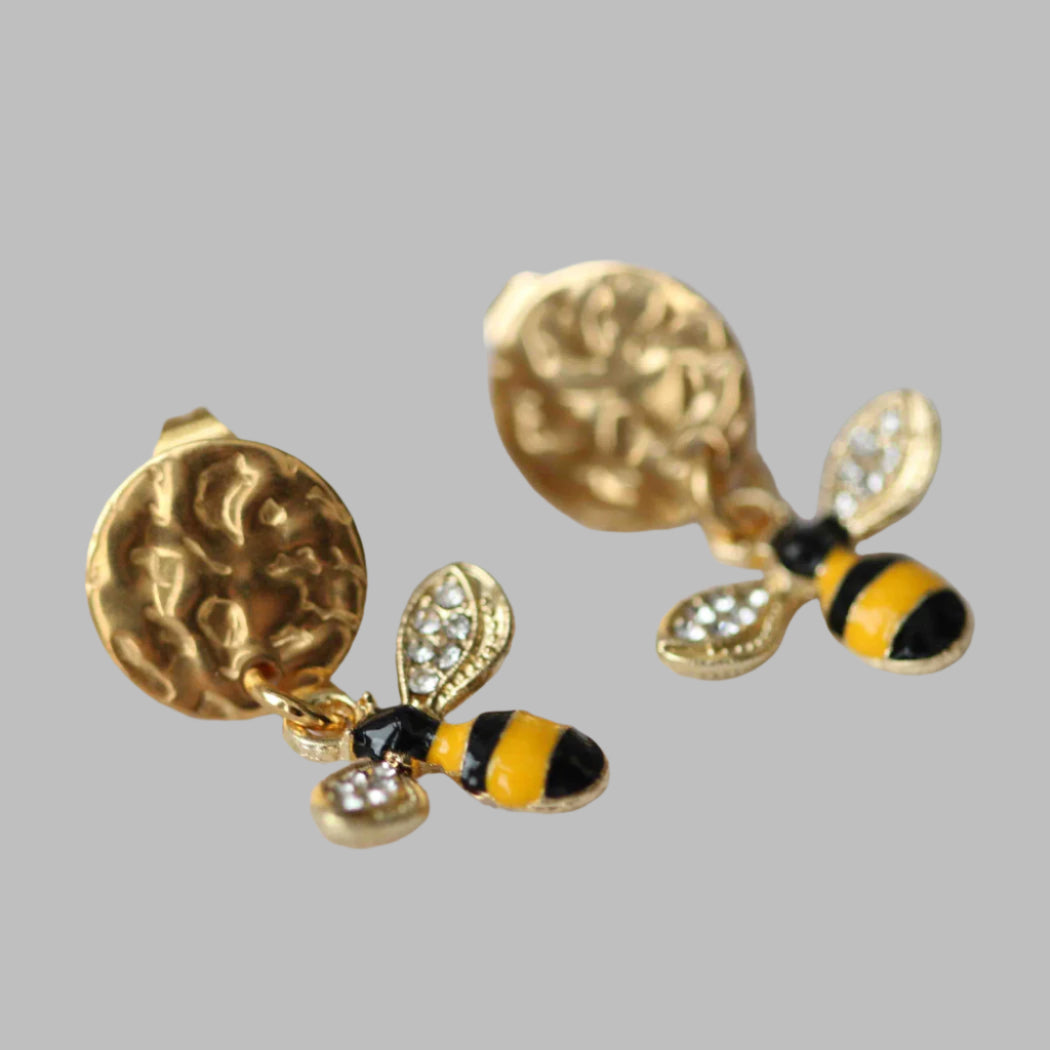 Gold bee-shaped earrings on a white background