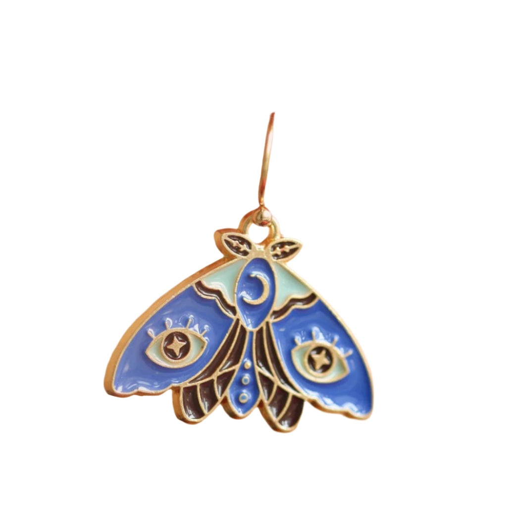 A gold-colored hook earrings with a blue butterfly design attached to it, displayed on a person's ear.