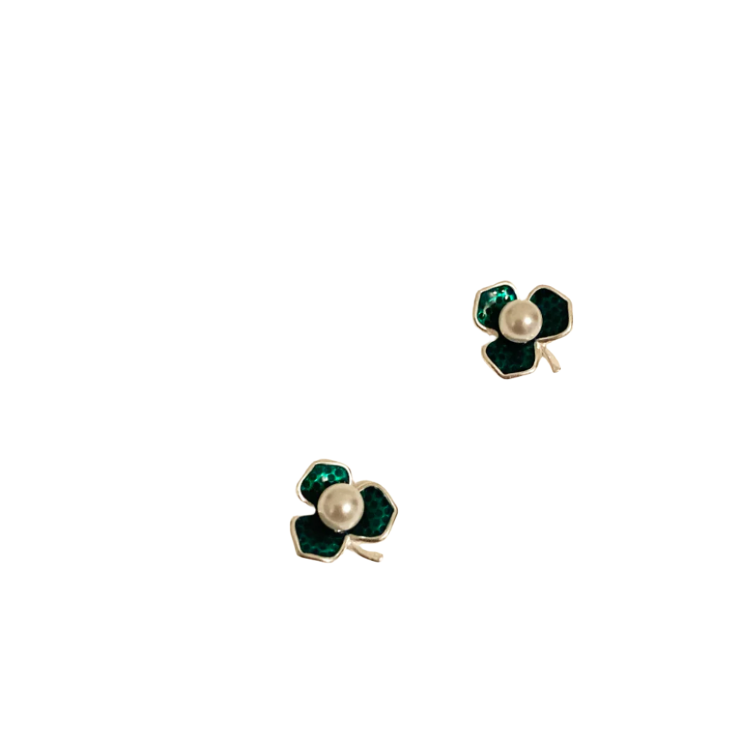 Clover-shaped earrings with pearl center on a SHB Studio card.