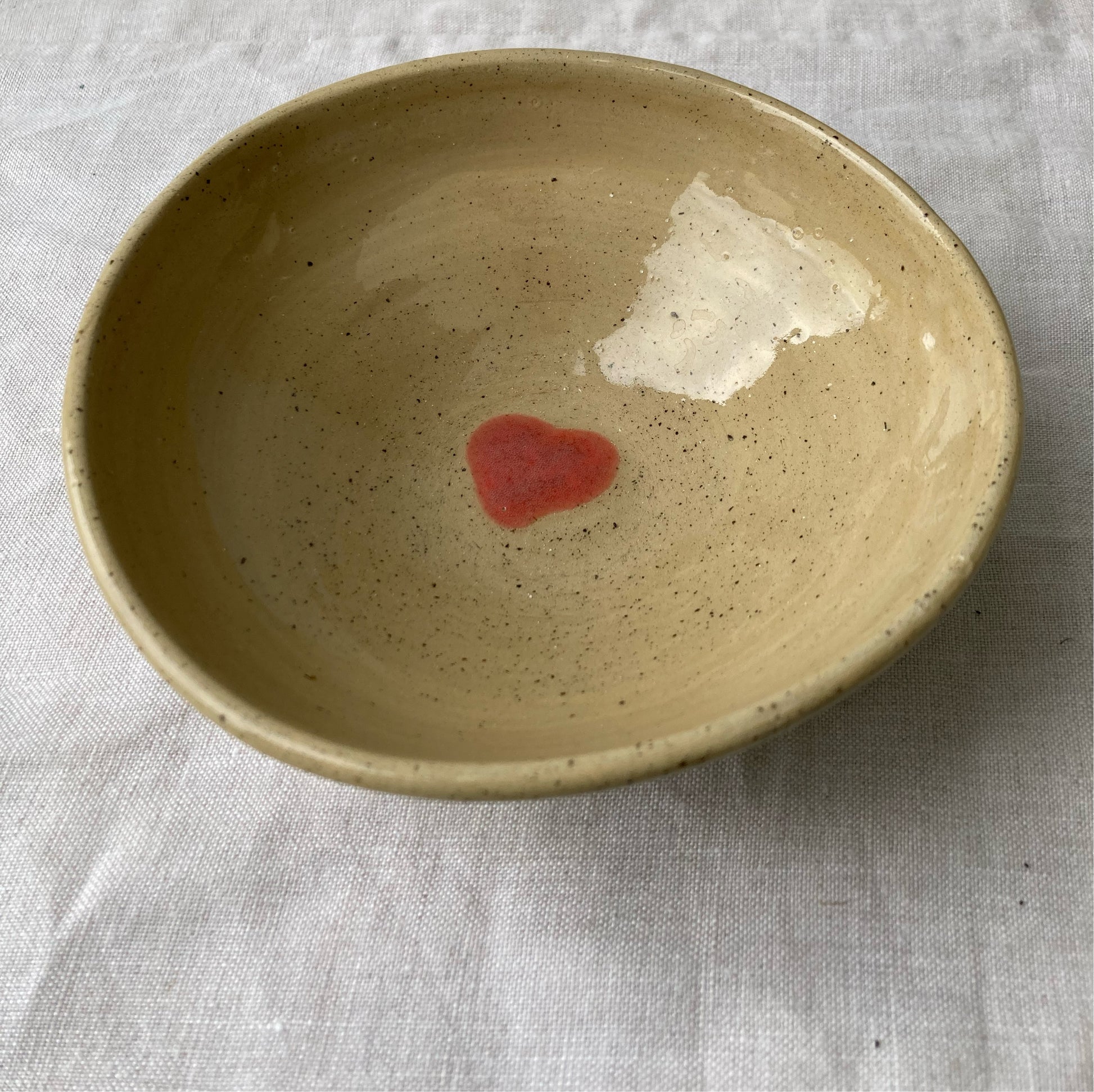 Beige ceramic bowl with red heart