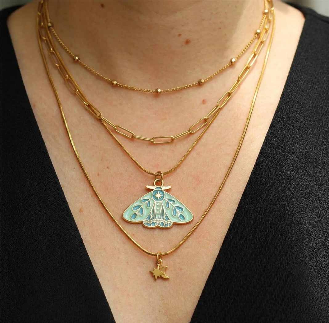 layered gold plated necklaces on woman neeck