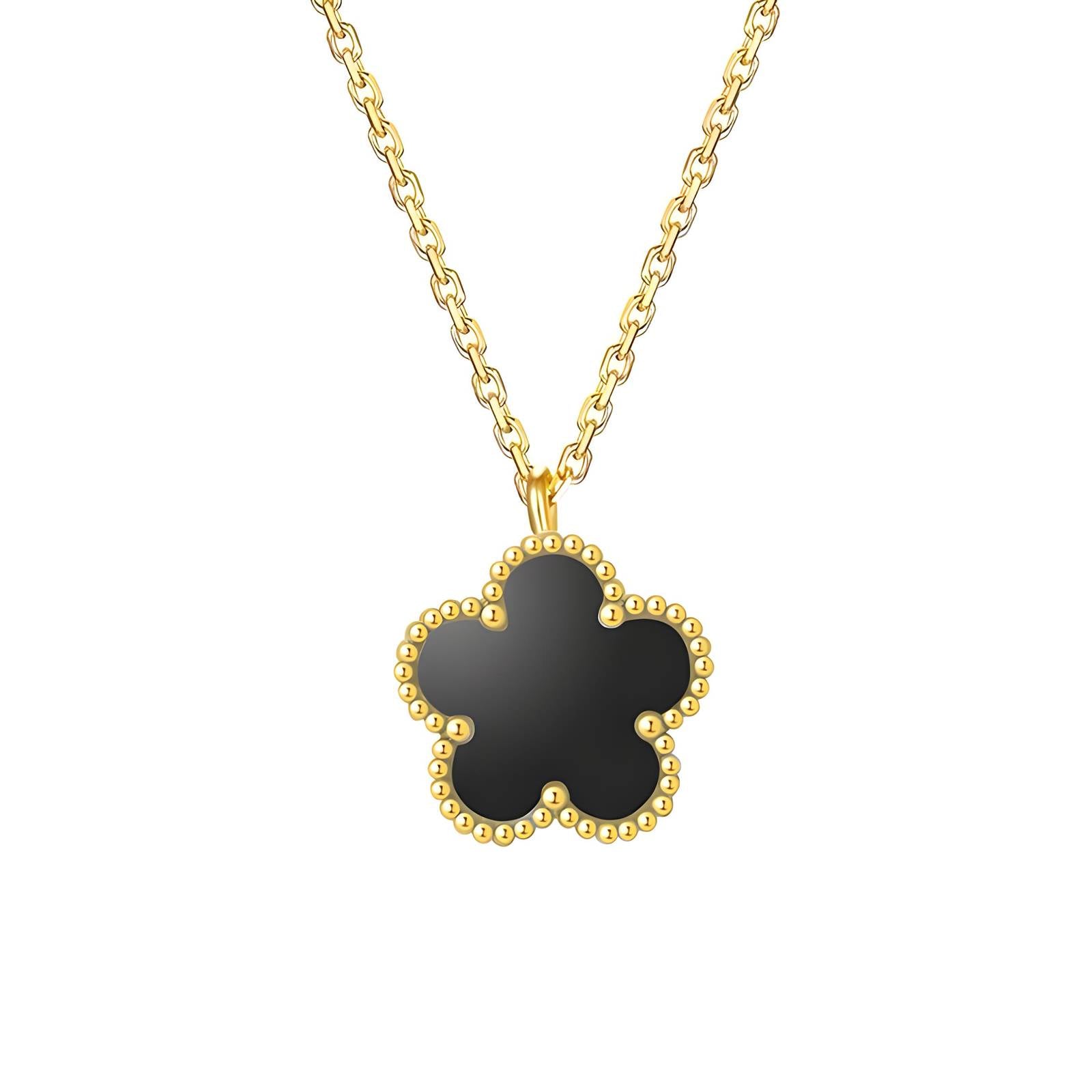A gold-plated necklace with a clover-shaped pendant on a white background.