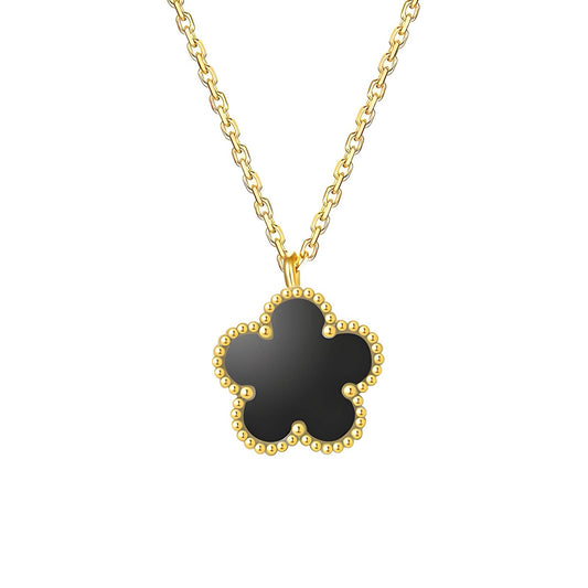 A gold-plated necklace with a clover-shaped pendant on a white background.