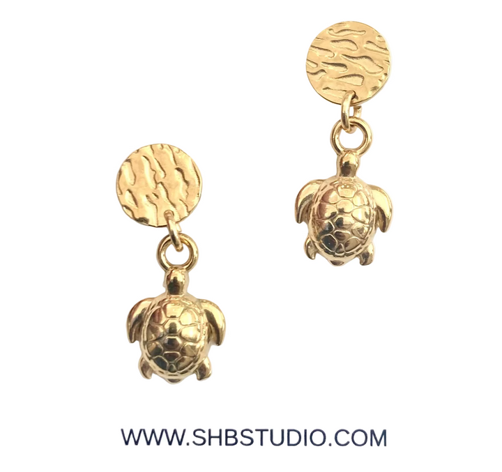 Gold turtle earrings on a white background with SHB Studio branding.