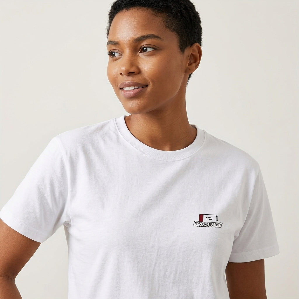 A woman wearing a white crewneck t-shirt with a small &