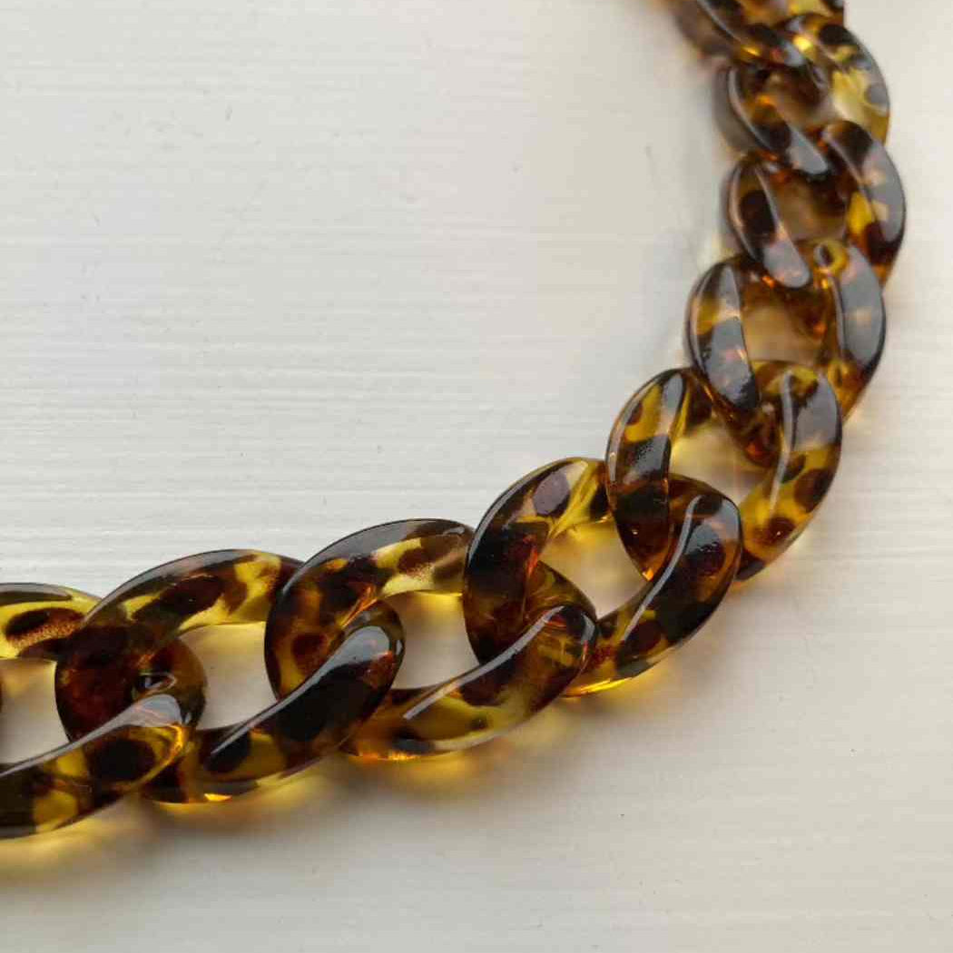 leopard acrylic chain necklace on a light background
