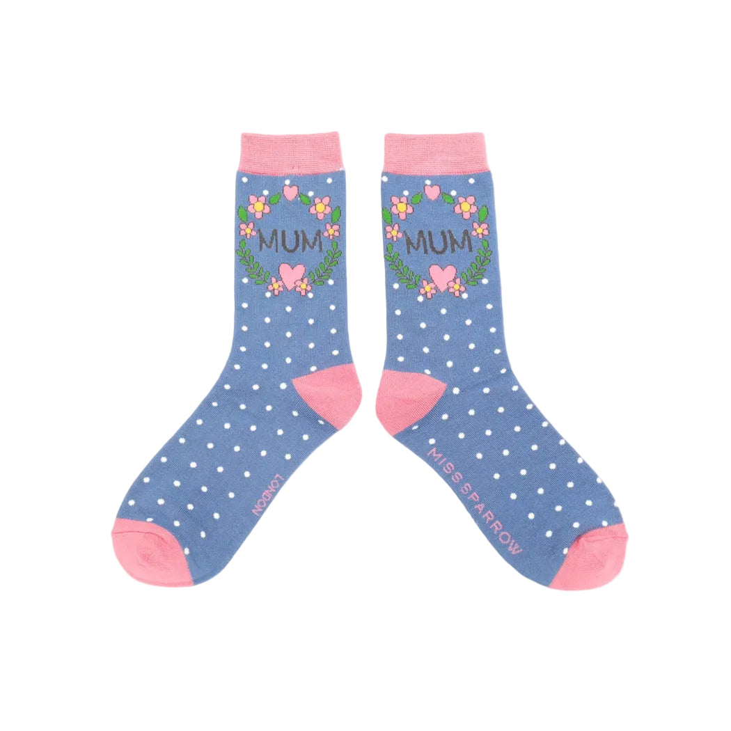 Pair of blue socks with white polka dots and pink accents, featuring the word 'MUM' and floral designs.