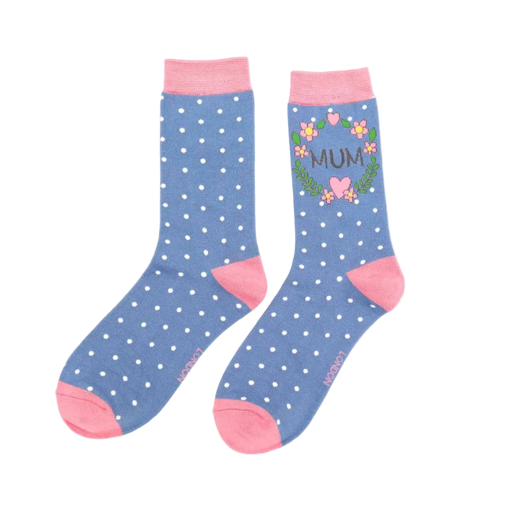 Pair of blue polka dot socks with pink accents and 'MUM' text on a white background
