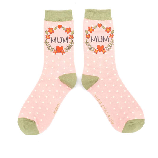 Pair of pink polka dot socks with 'MUM' and floral designs on a white background