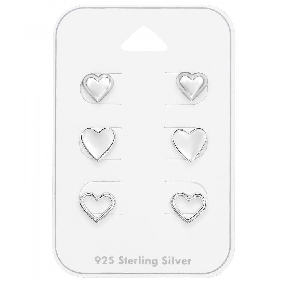 Set of three pairs of sterling silver heart stud earrings on a gift card