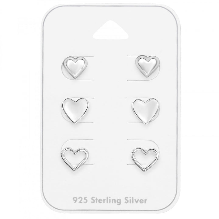 Set of three pairs of sterling silver heart stud earrings on a gift card