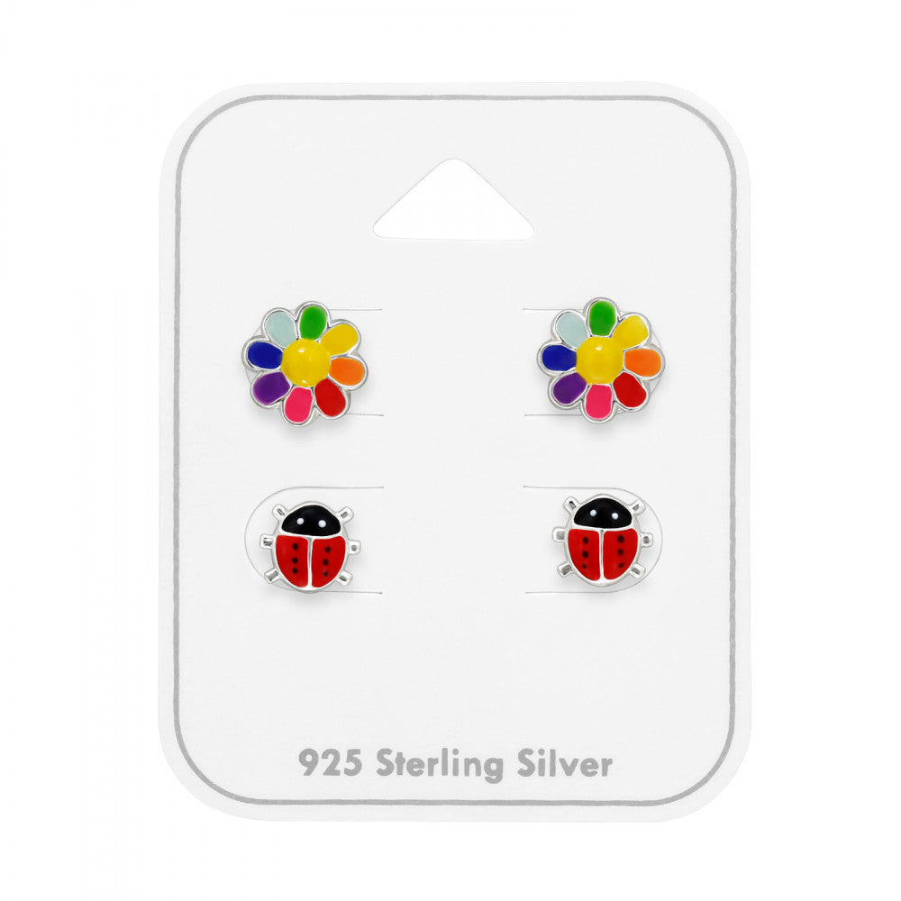 Two pairs of sterling silver stud earrings, rainbow flowers and red ladybirds, on a gift card