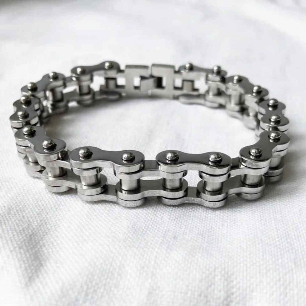 Silver chain bracelet on a white fabric background