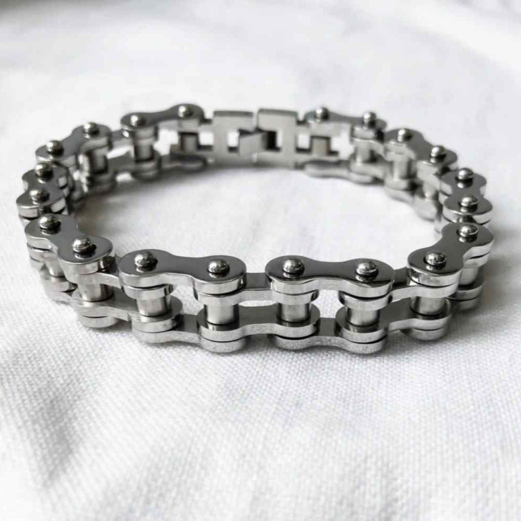 Silver chain bracelet on a white fabric background