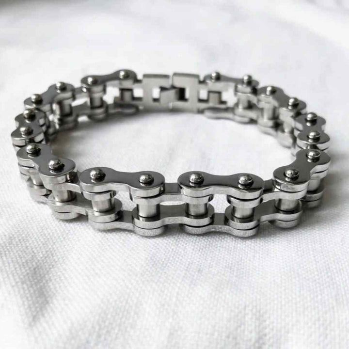 Silver chain bracelet on a white fabric background