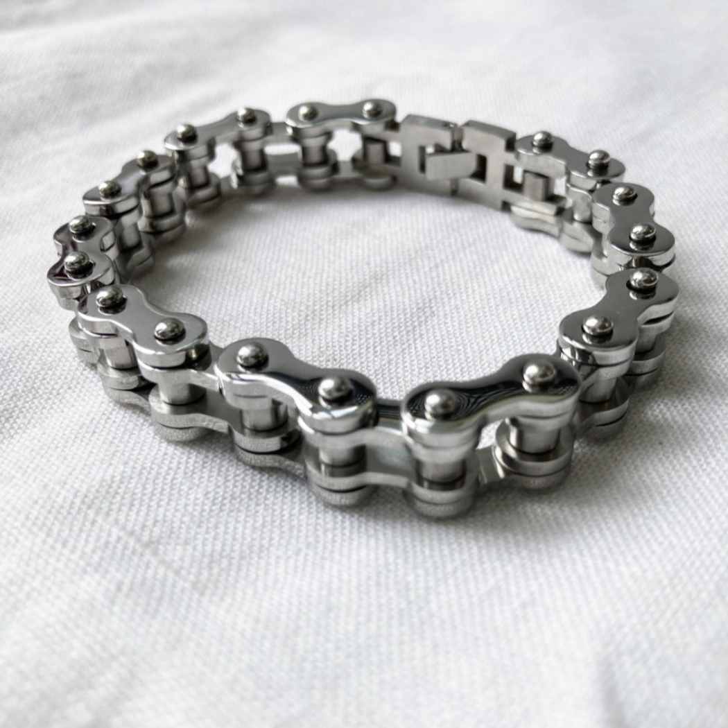 Silver stainless steel bracelet with chain design on a white background
