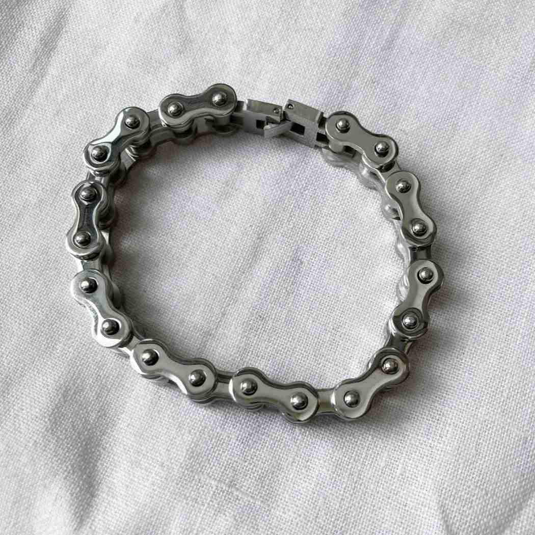 Bracelet made of interlocking metal rings on a white fabric background