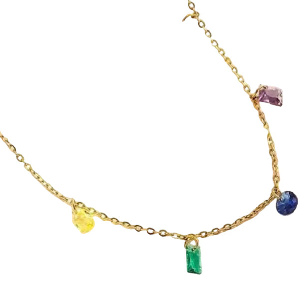Gold necklace with colorful gemstones on a textured white surface