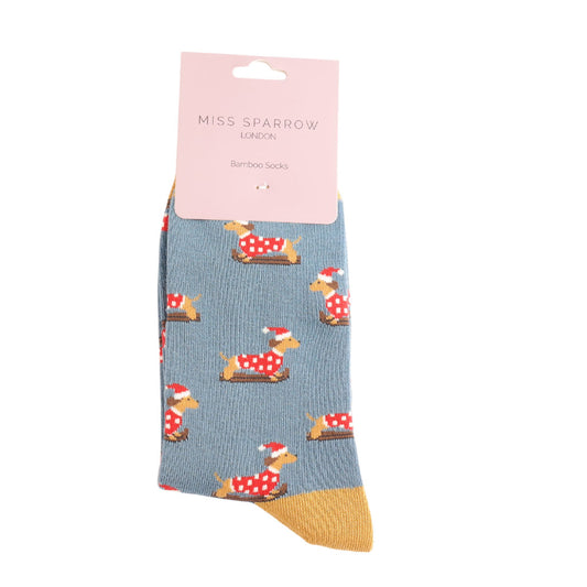 Blue sock with dog pattern and pink label on white background