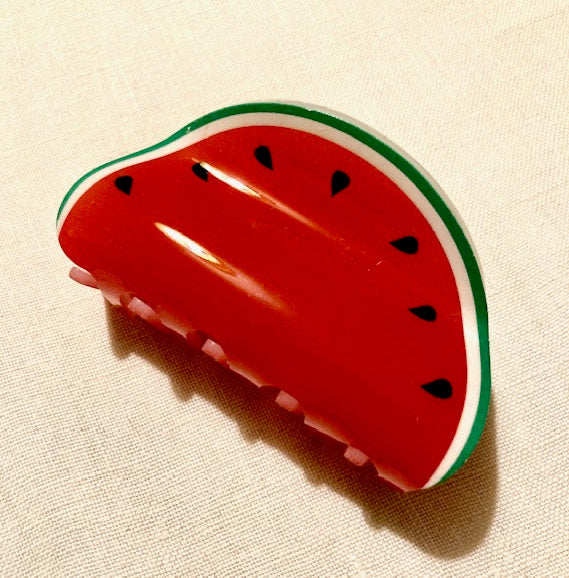 Watermelon-shaped hair claw on a beige background