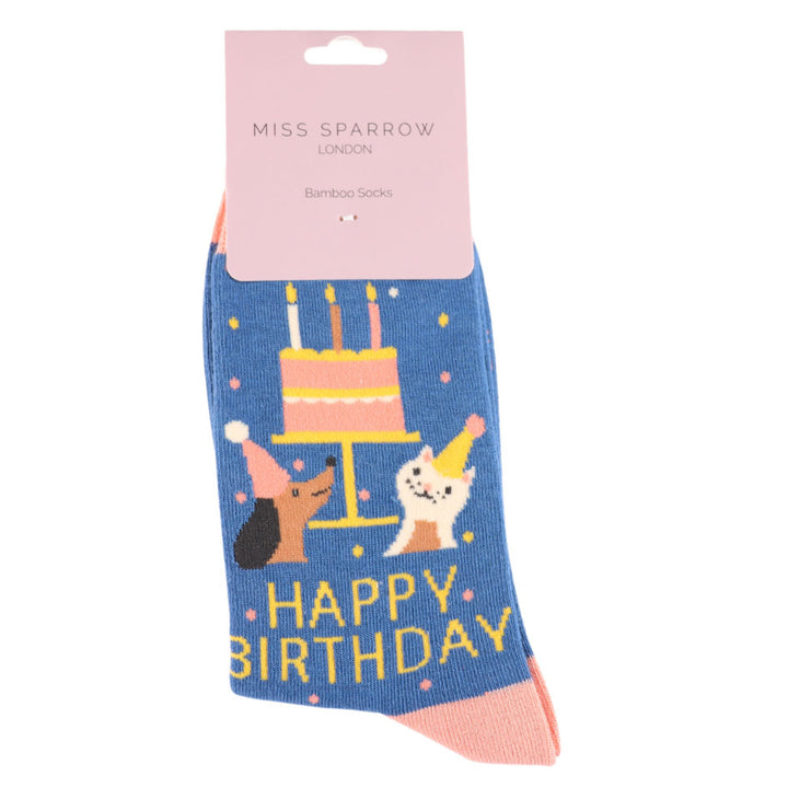 Birthday-themed socks with a cake and animals design, featuring &