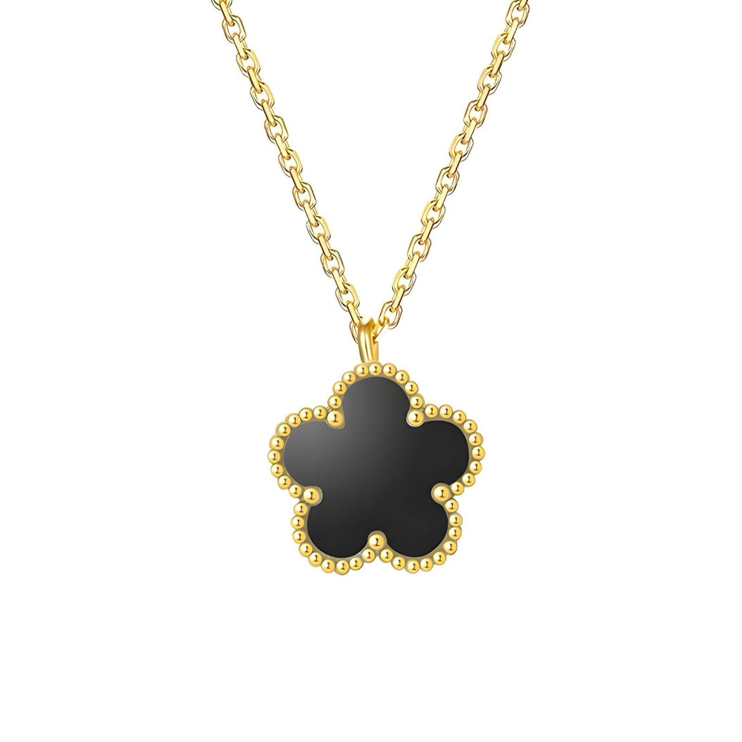 A gold-plated necklace with a clover-shaped pendant on a white background.