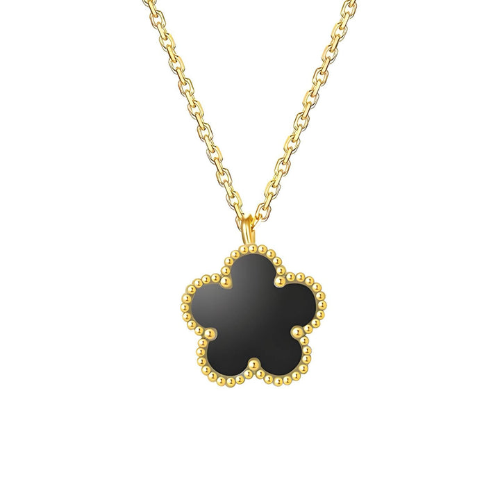 A gold-plated necklace with a clover-shaped pendant on a white background.