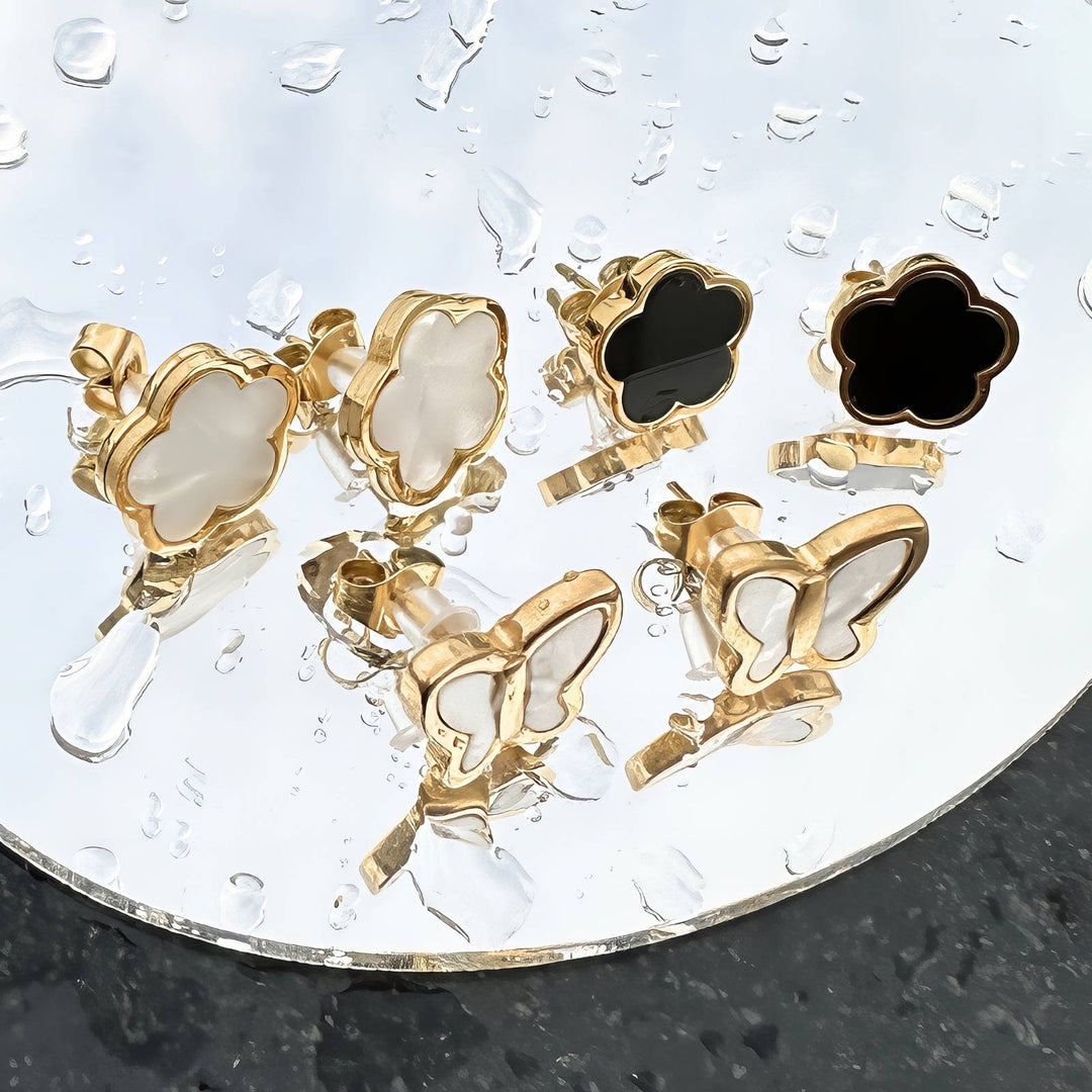 Black Clover Earrings, close-up of gold and black enamel clover detail