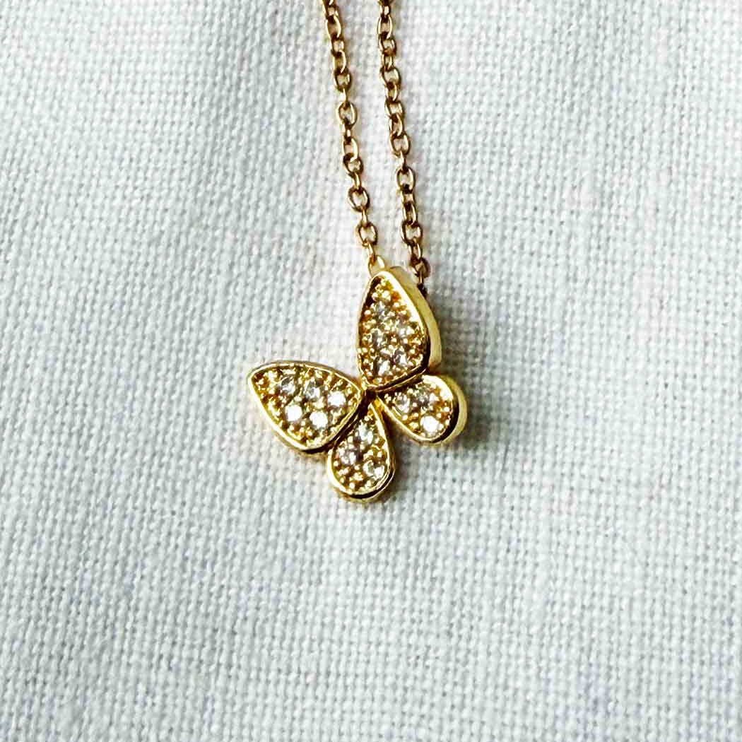 butterfly necklace on white background