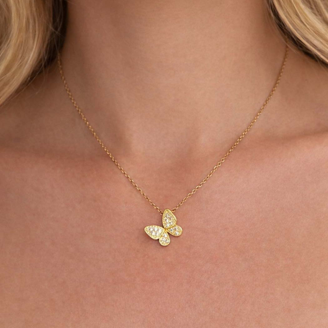 butterfly necklace with gold chain.
