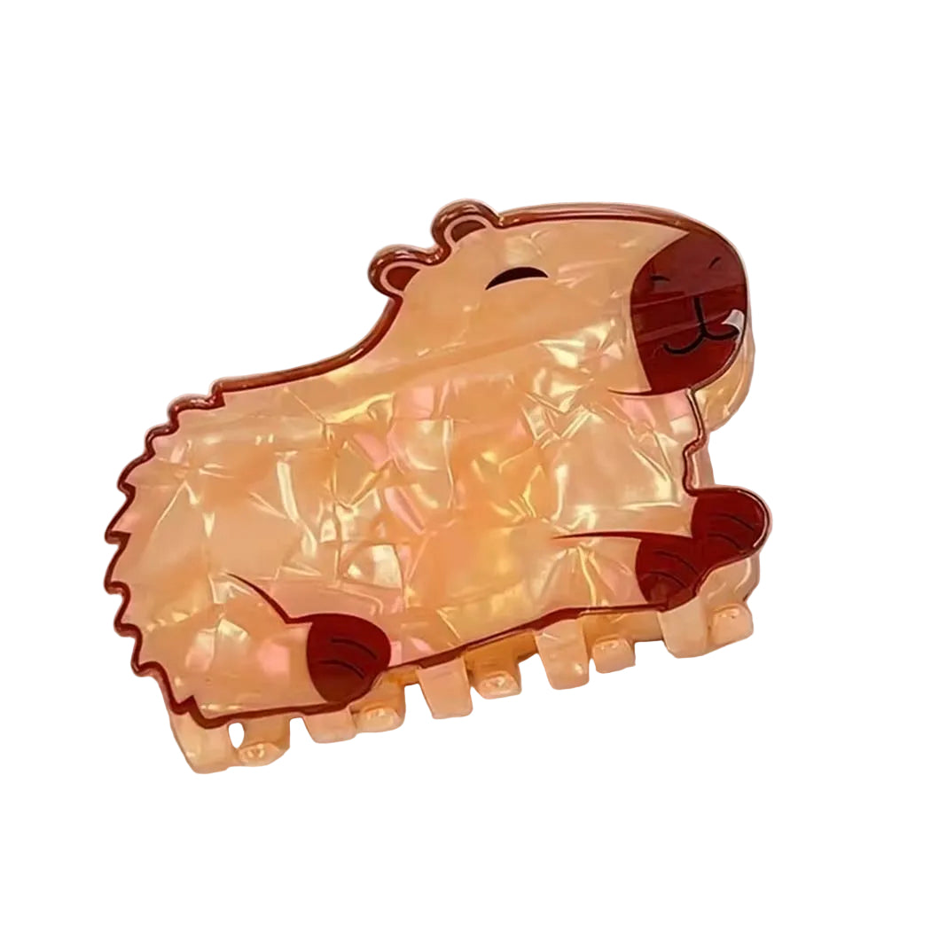 capybara light orange hair claw on a white fabric background