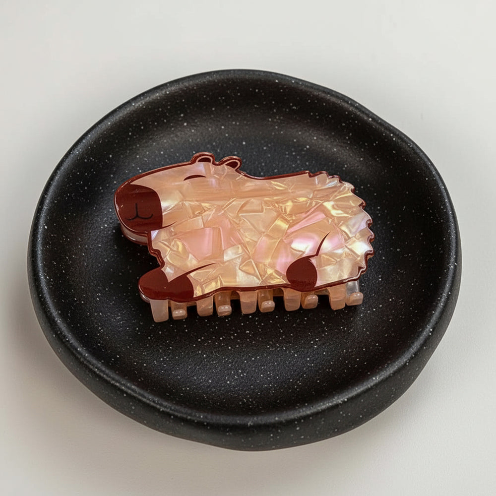 Round ceramic plate with a capybara hair claw a light background