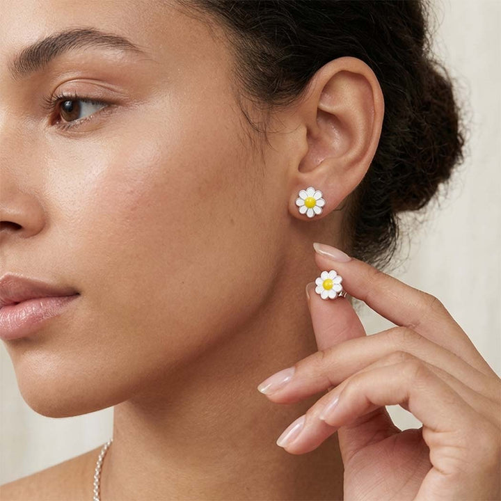 woman wearing flower daisy white and yellow studs