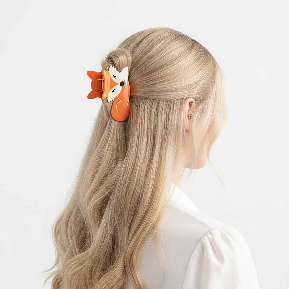 Person wearing a fox-shaped hair clip in their hair, sitting indoors.