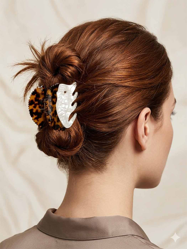 Woman with styled hair featuring a decorative hair clip against a neutral background