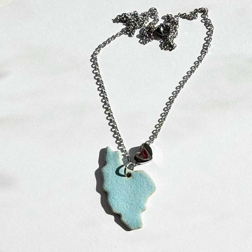 Necklace with a blue  iran map pendant on a white background