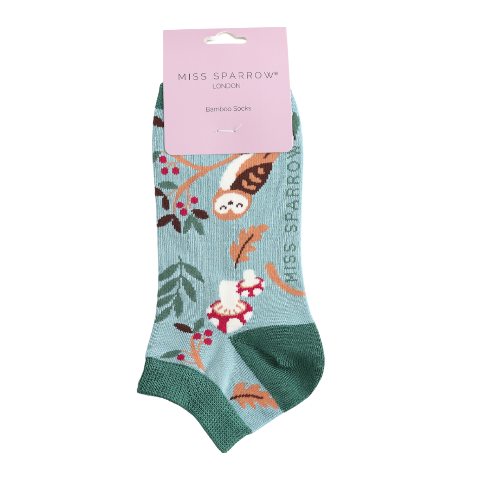 Socks with nature-themed design and 'Miss Sparrow' packaging on a white background