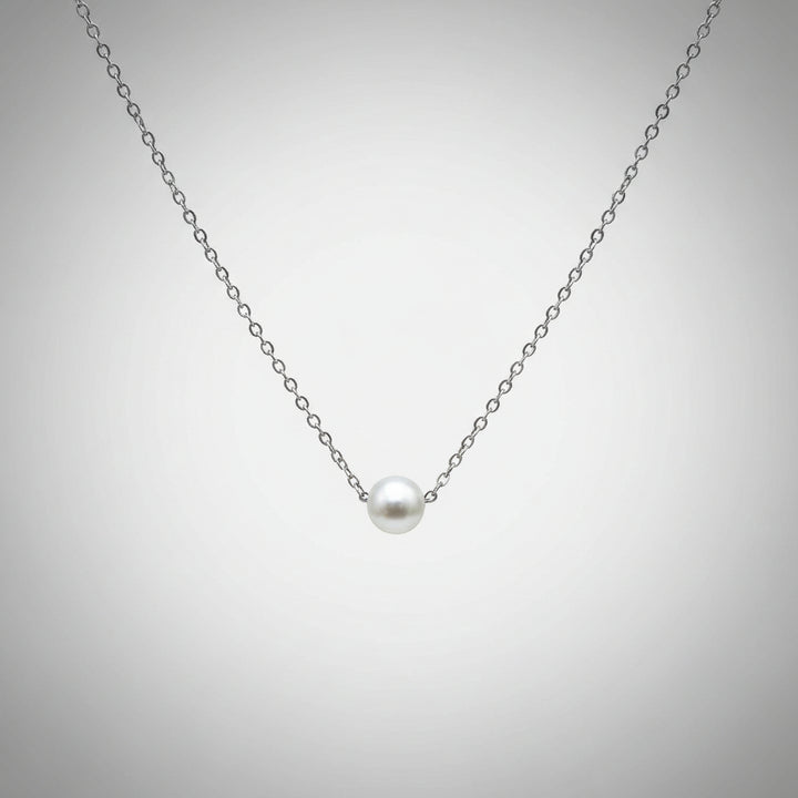 Pearl necklace on gray background.