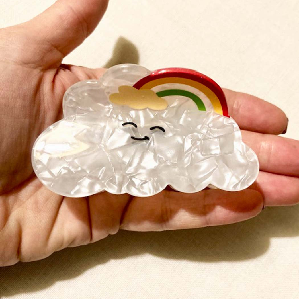 rainbow hair claw with smily face on cloud.