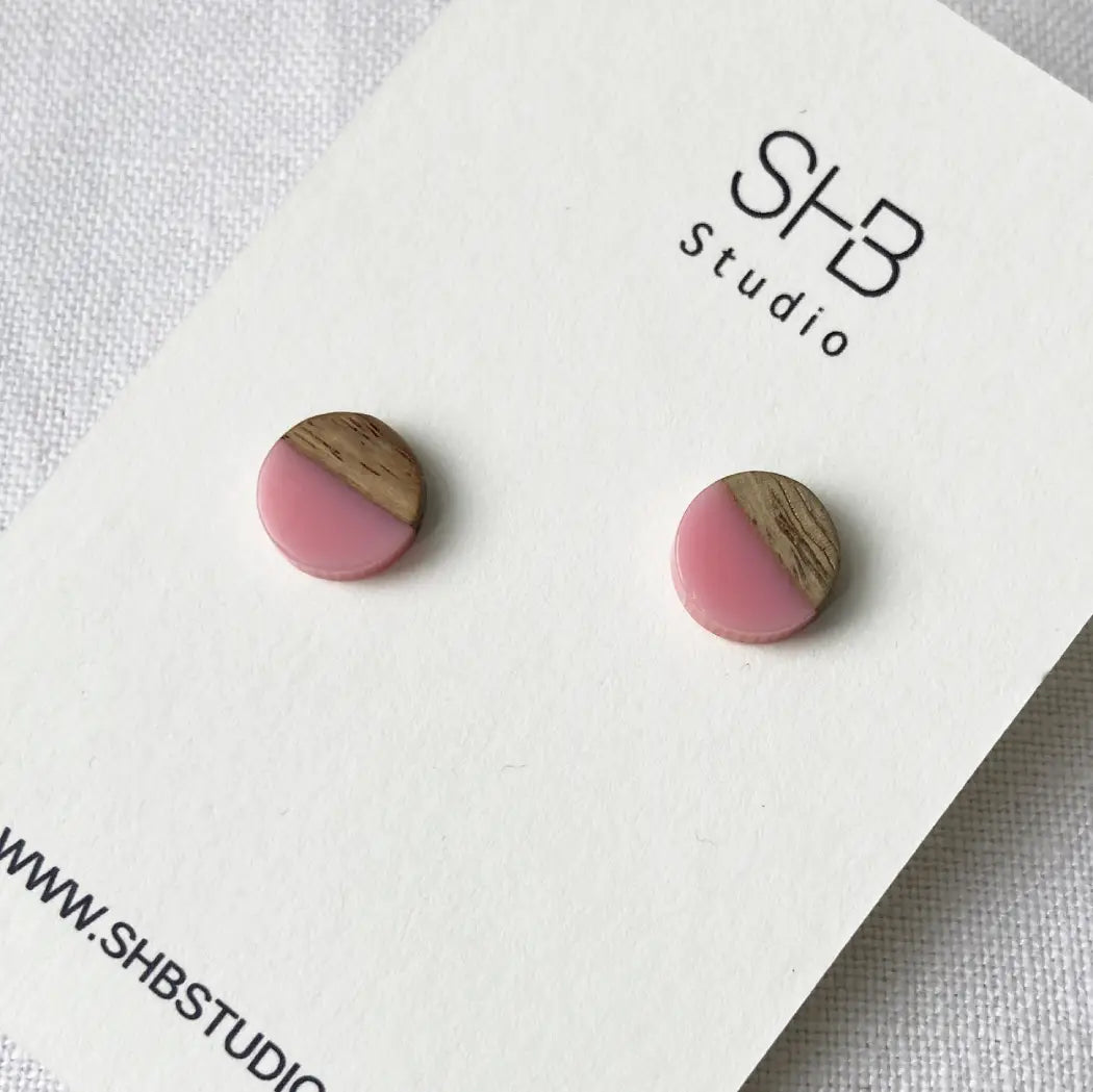 Half Wooden and half light pink matt colour  resin earrings on a SHB Studio card.