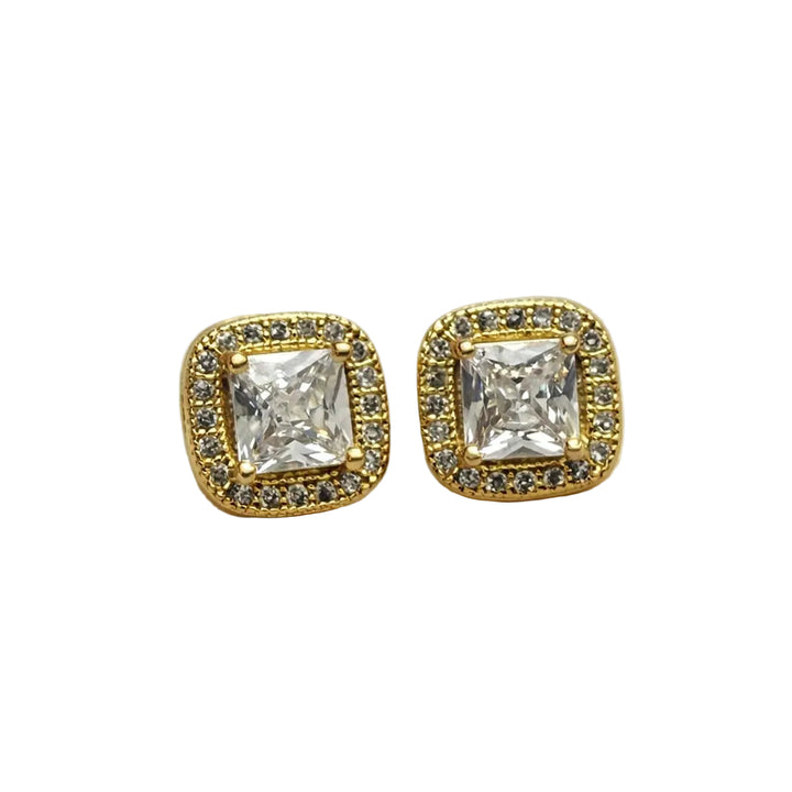 Gold square earrings with clear gemstones on a white satin background