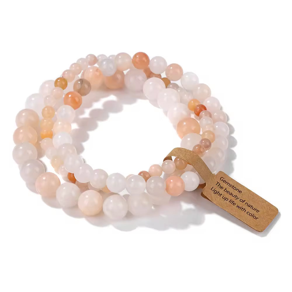 Set of beaded bracelets with a tag on a white background