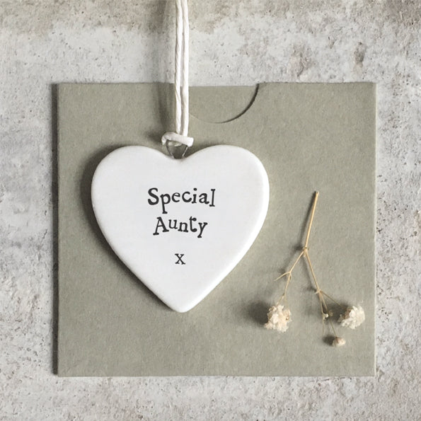 Heart-shaped ceramic tag with 'Special Aunty x' text on a gray background