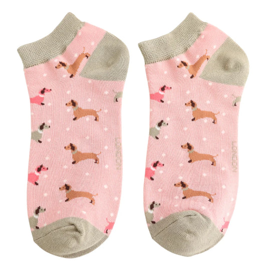 Pair of pink socks with dachshund patterns on a white background