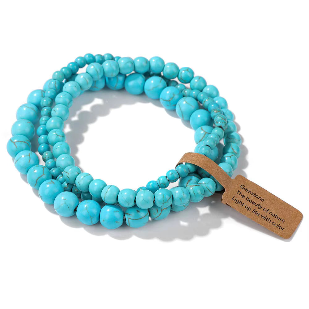 Turquoise beaded bracelet with a brown tag on a white background