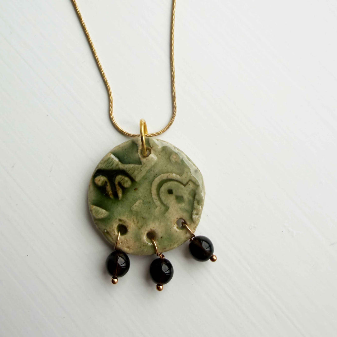 green disc ceramic handmade with 3 black gemstone beads