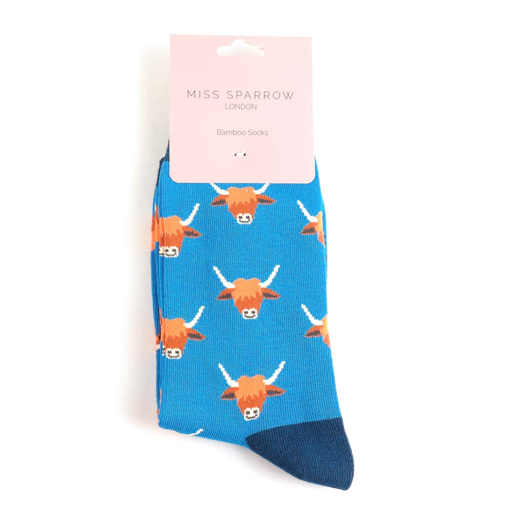 Blue sock with highland cow pattern and &
