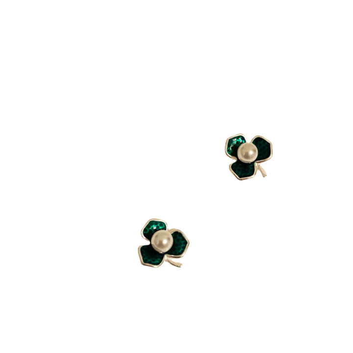 Clover-shaped earrings with pearl center on a SHB Studio card.