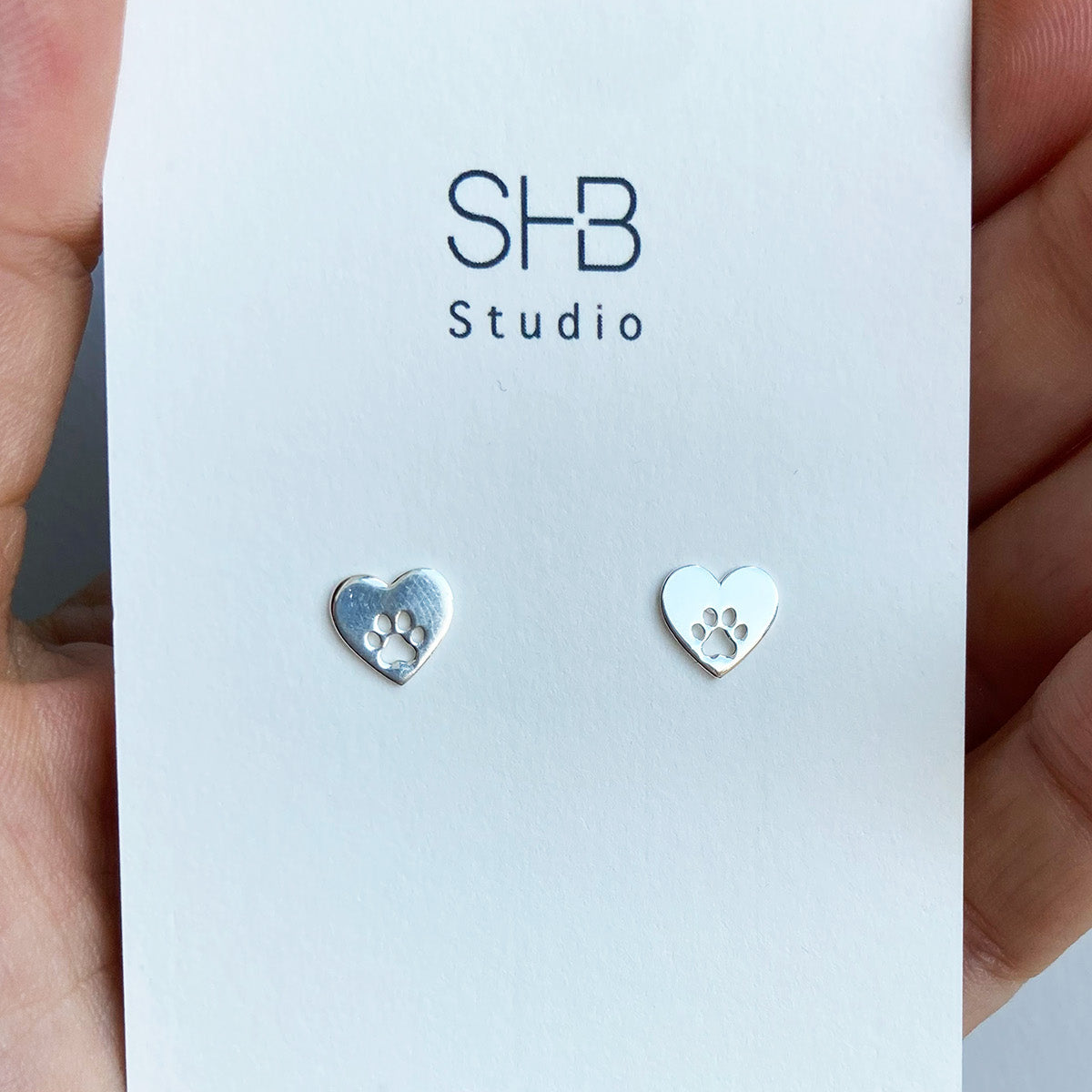paw studs inside hear shape silver studs.